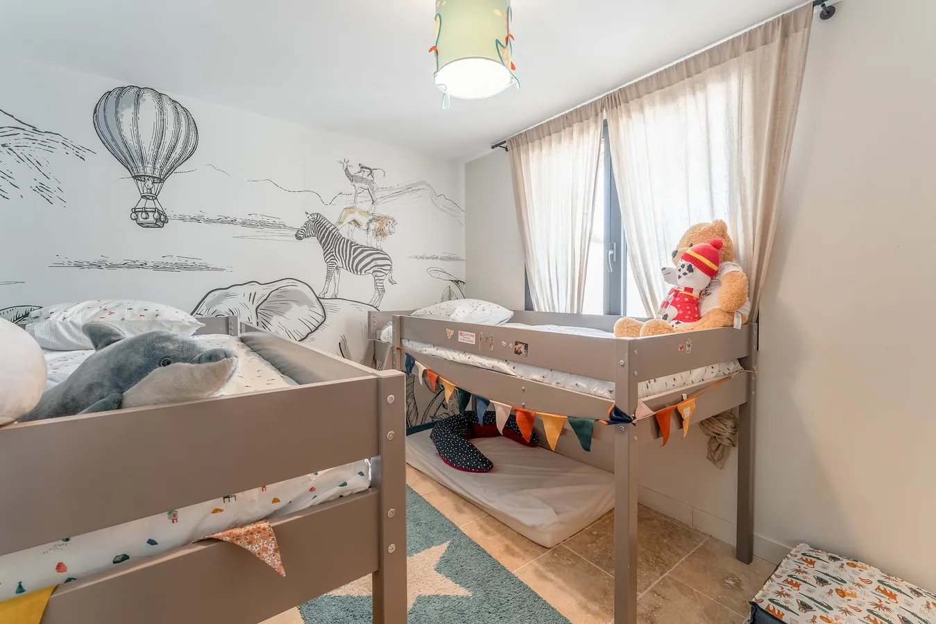 Chambre enfants du T2 avec lits superposés et fresque